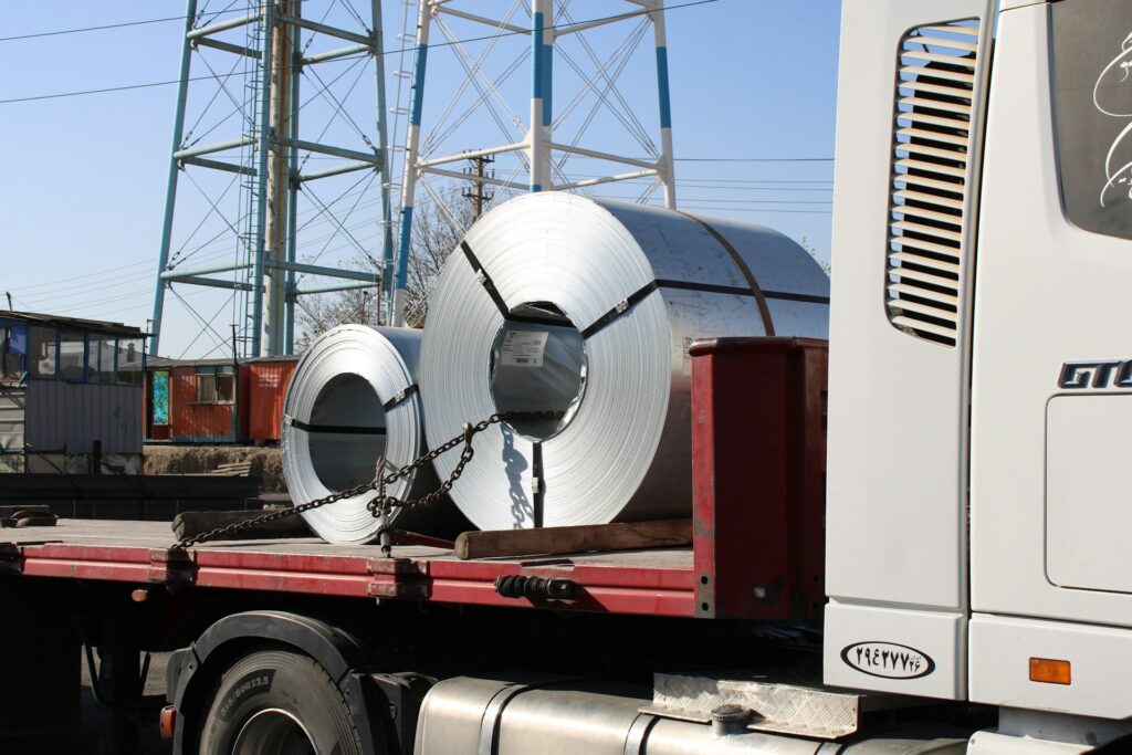 Heavy steel products loaded onto transport trucks for delivery