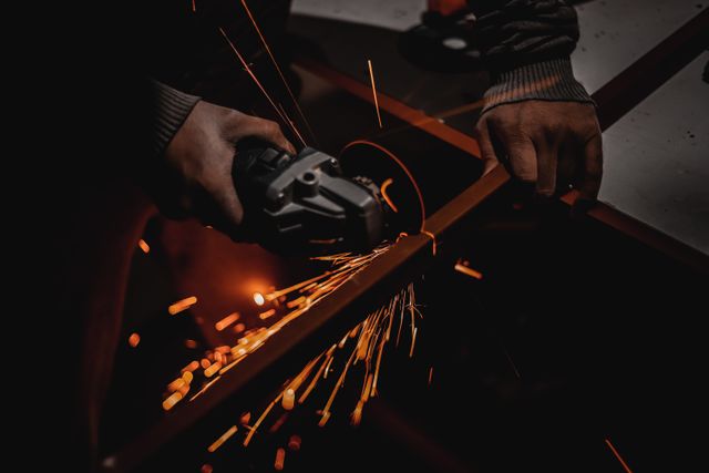 Skilled worker performing manual steel cutting for custom fabrication