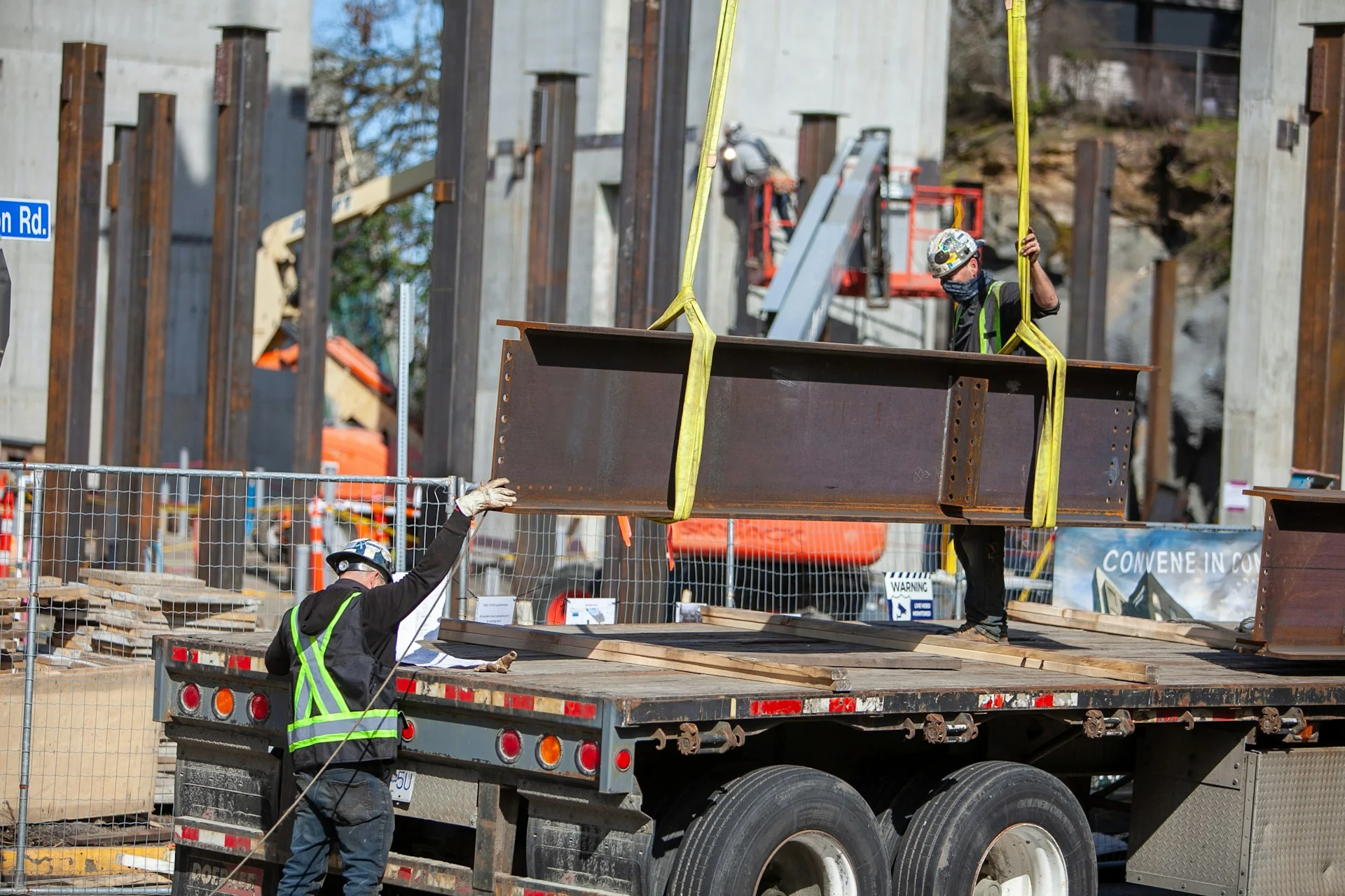 Steel coils and structural steel being transported using specialized transport vehicles